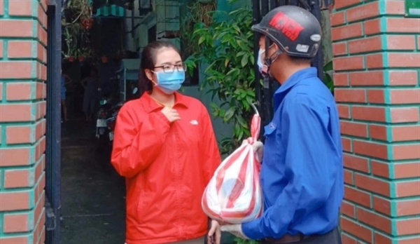 A volunteer from Karma Waters Charitable Association delivers a food pack in Vietnam. Photo: Handout