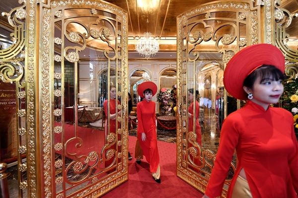 Staff wait to welcome guests in the lobby of the newly-inaugurated Dolce Hanoi Golden Lake hotel, the world's first gold-plated hotel, in Hanoi on July 2, 2020. | CREDIT: MANAN VATSYAYANA/AFP VIA GETTY IMAGES