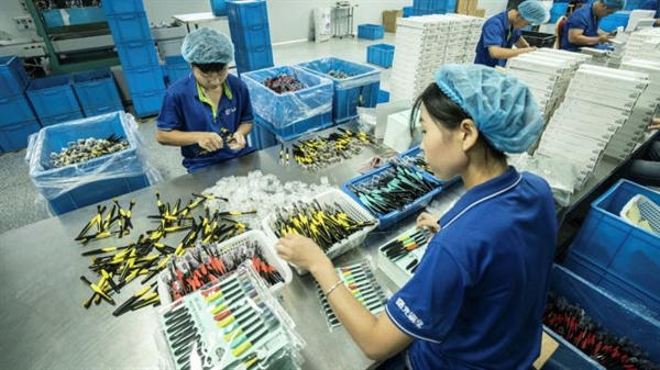 Các nhân viên trên một dây chuyền sản xuất tại nhà máy sản xuất bàn chải đánh răng Shuguang ở Dương Châu, Trung Quốc. Ảnh: Bloomberg.