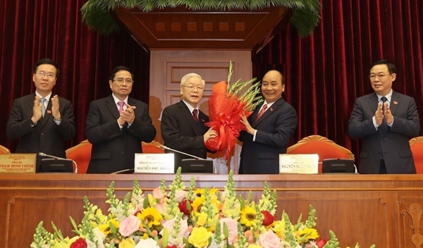 Prime Minister Nguyen Xuan Phuc, on behalf of the Politburo, congrats Nguyen Phu Trong on being elected for a third term as Party General Secretary. Photo by VNA.