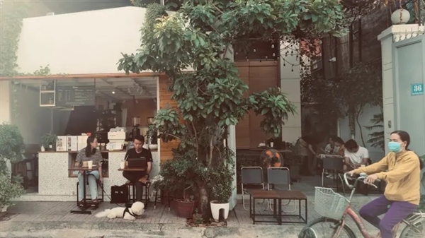 Coffee devotees bring pets and watch street life at Mindfully Cafe in Ho Chi Minh City. Photo by Lien Hoang.