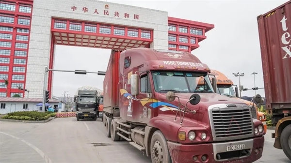 Trucks pass through a border crossing with China: Vietnamese exporters have expressed surprise at the lingering weakness in their sales. Photo by Reuters.