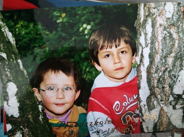 Paweł Górski (wearing glass) is seen with his friend during his childhood.