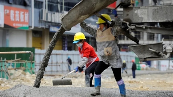 Workers pour concrete at a site in Renhuai, Guizhou province, China in 2020. Photo by China Daily via Reuters.