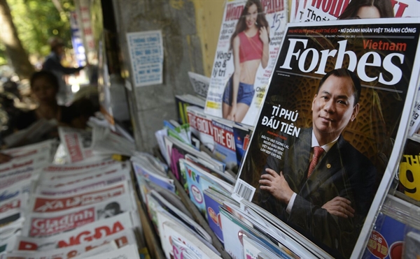 Vuong on the cover of a Vietnamese version of Forbes Magazine in 2013. Photo by Hoang Dinh Nam/AFP via Getty Images.