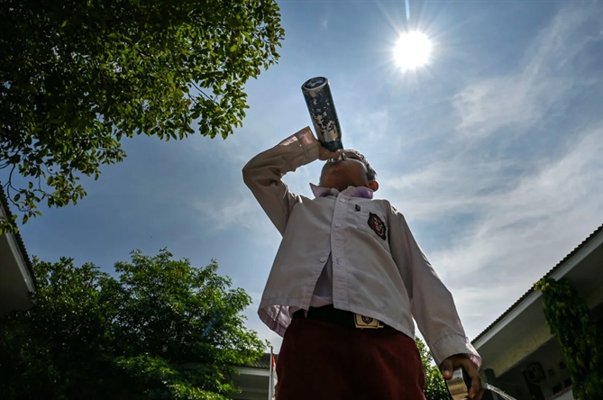 Học sinh Indonesia dưới thời tiết nằng nóng. Ảnh: AFP