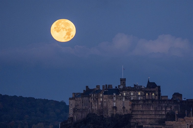 Mặt trăng lặn phía sau Lâu đài Edinburgh ở Scotland vào thứ năm