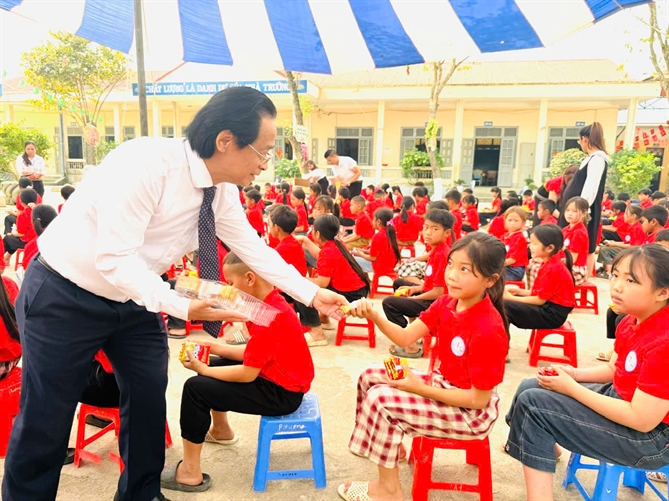 PGS.TS Nguyễn Lân Trung trao quà tận tay cho các em nhỏ