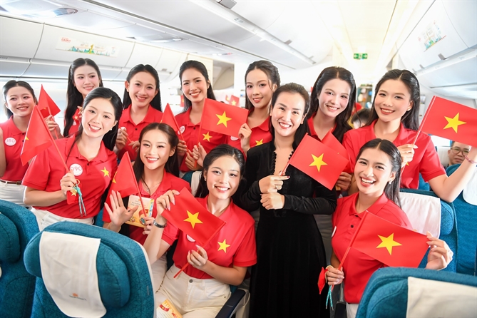 Những lá cờ được trao trước đó cùng được giơ cao. Các thí sinh Hoa hậu Việt Nam và nhiều hành khách hát theo tiếng nhạc.